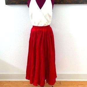 100% red silk pleated midi skirt.